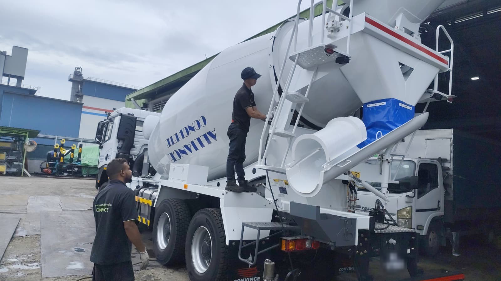 Alliance Concrete cement mixer with crew at the rear chute